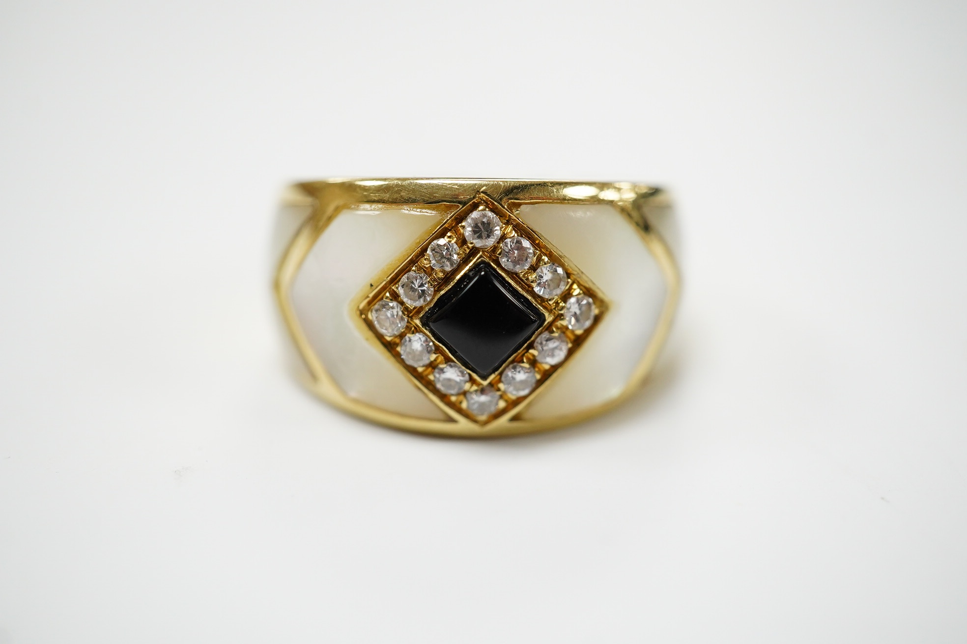 An Italian? yellow metal, mother of pearl, black enamel and diamond cluster set dress ring, size Q, gross weight 8.3 grams. Condition - fair